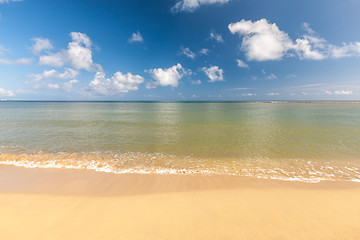 Image showing Beach on tropical island. Clear blue water, sand, clouds. 