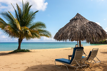 Image showing Sunbed and umbrella on a tropical beach