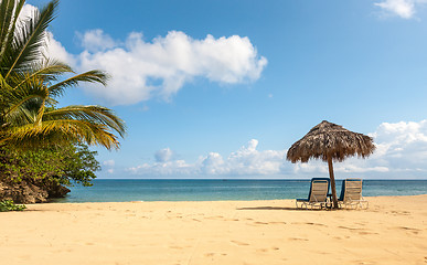 Image showing Sunbed and umbrella on a tropical beach