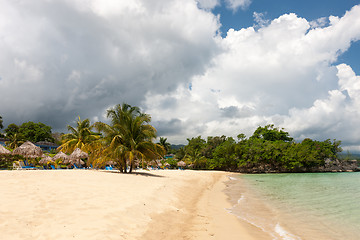 Image showing Beach on tropical island. Clear blue water, sand, clouds. 