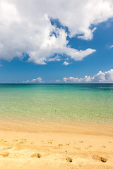 Image showing Beach on tropical island. Clear blue water, sand, clouds. 