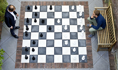 Image showing Two men playing a game of outdoor chess