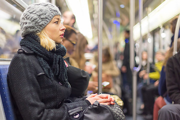 Image showing Woman traveling by subway full of people.