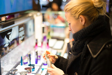 Image showing Beautiful woman shopping in beauty store.