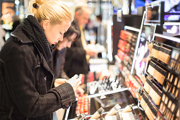 Image showing Beautiful woman shopping in beauty store.