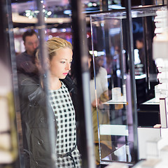 Image showing Beautiful woman standing in front of showcase.