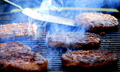 Image showing Hamburgers grilling.