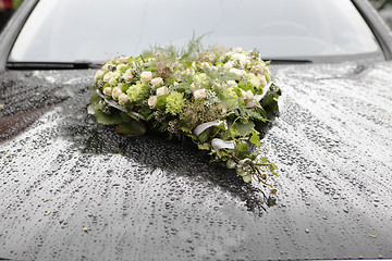 Image showing Flower arrangement on car
