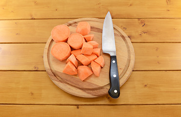 Image showing Sweet potato chopped with a knife on a cutting board