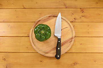 Image showing Green pepper with a knife on a cutting board