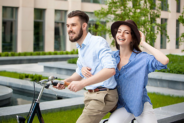 Image showing Young couple sitting on a bicycle 