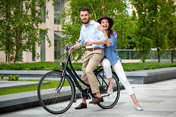 Image showing Young couple sitting on a bicycle 