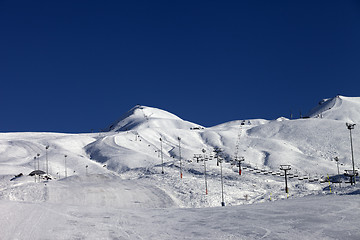 Image showing Winter mountains and ski slope at sun day