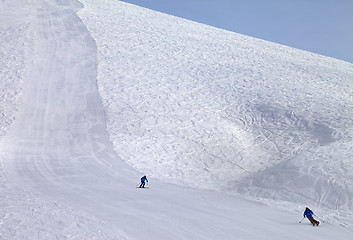 Image showing Ski slope and skiers at sun day