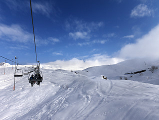 Image showing Chair-lift and off-piste slope in wind day