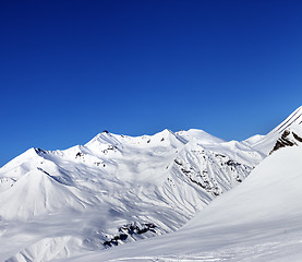 Image showing View on ski slope and beautiful mountains at sun day