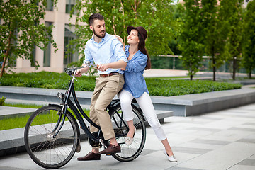 Image showing Young couple sitting on a bicycle 