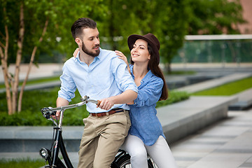 Image showing Young couple sitting on a bicycle 