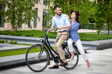 Image showing Young couple sitting on a bicycle 