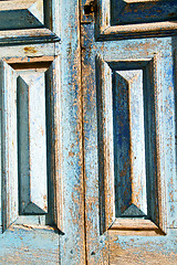 Image showing dirty  paint in the blue  door  rusty nail