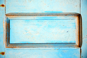 Image showing dirty stripped paint in    wood door and rusty nail