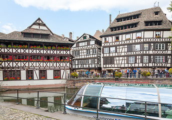 Image showing STRASBOURG, FRANCE - SEPTEMBER 26 2008: Strasbourg, water canal in Petite France area. timbered houses and trees in  Alsace, France. in the foreground water bus