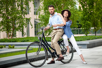 Image showing Young couple sitting on a bicycle 