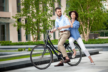 Image showing Young couple sitting on a bicycle 