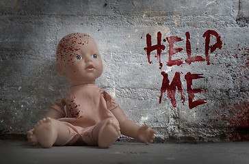 Image showing Concept of child abuse - Bloody doll