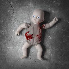 Image showing Concept of child abuse - Bloody doll