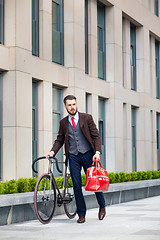 Image showing Handsome businessman and his bicycle