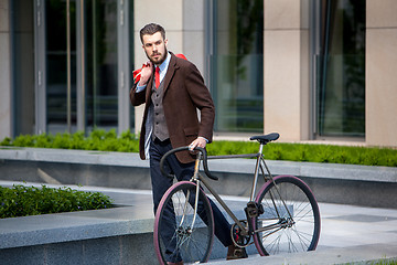 Image showing Handsome businessman and his bicycle