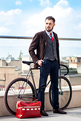 Image showing Handsome businessman and his bicycle