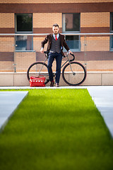 Image showing Handsome businessman and his bicycle