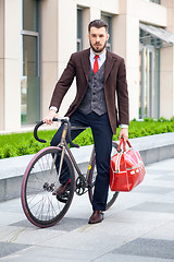 Image showing Handsome businessman and his bicycle