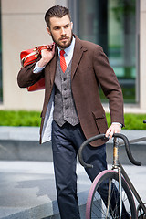 Image showing Handsome businessman and his bicycle