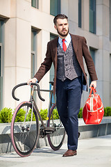 Image showing Handsome businessman and his bicycle