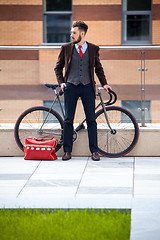 Image showing Handsome businessman and his bicycle