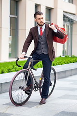 Image showing Handsome businessman and his bicycle