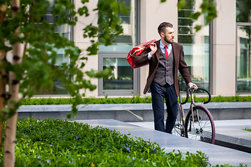 Image showing Handsome businessman and his bicycle