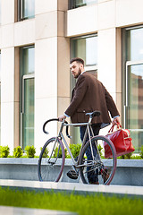 Image showing Handsome businessman and his bicycle