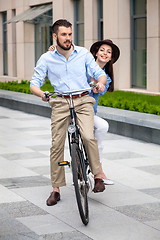 Image showing Young couple sitting on a bicycle 