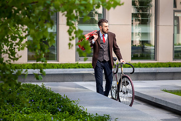 Image showing Handsome businessman and his bicycle