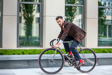 Image showing Handsome businessman and his bicycle