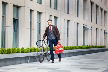 Image showing Handsome businessman and his bicycle