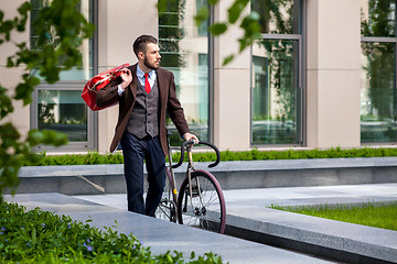 Image showing Handsome businessman and his bicycle