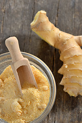 Image showing Fresh ginger root and ground ginger spice 