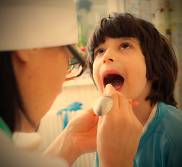 Image showing boy showing his throat to doctor