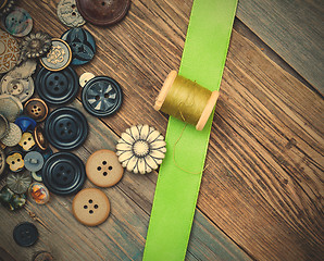 Image showing vintage buttons, spool with thread and green tape