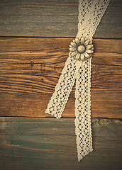 Image showing silvery button flower and lace tape